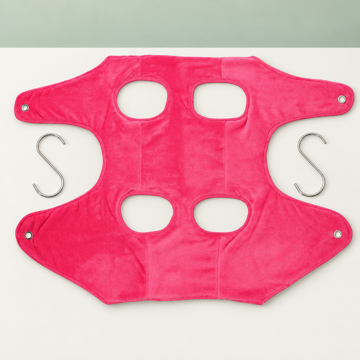 Petaluni pet grooming hammock in Pink on a sage background
